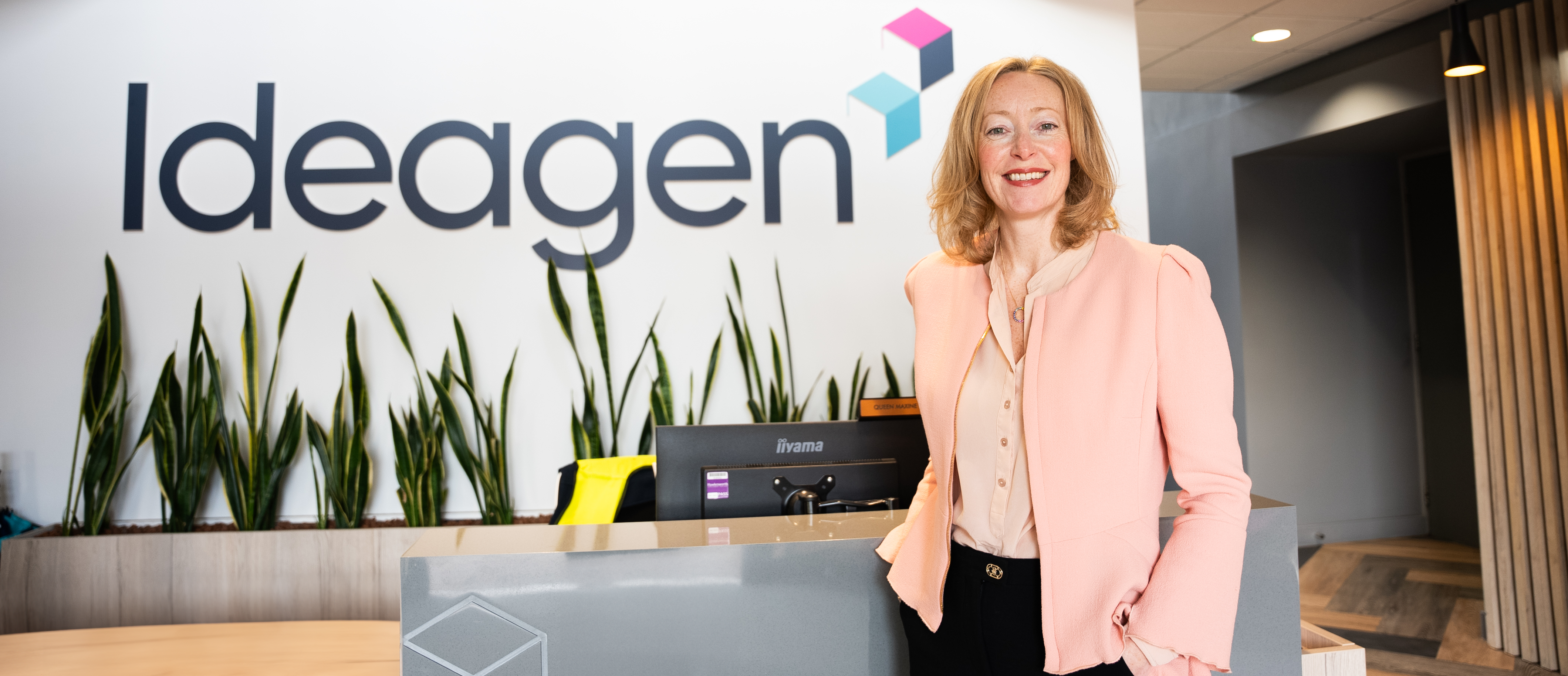 EVP Sam Honey in front of the Ideagen sign